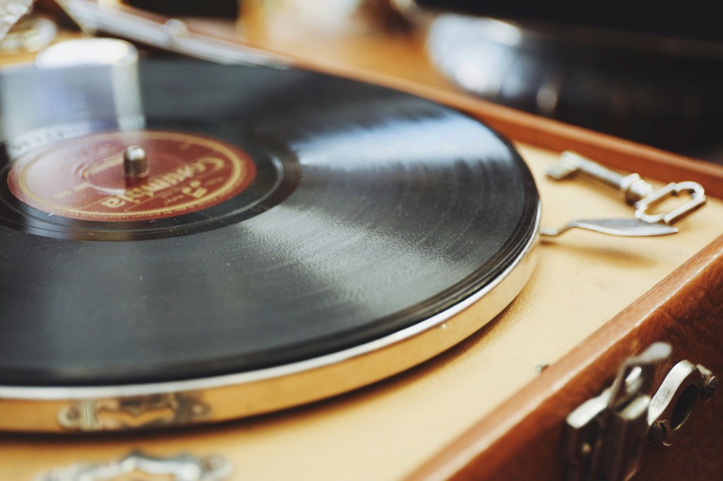 Turntable playing a vinyl record in a living room setting